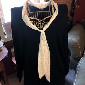 Black sweater with white polka dot tie.